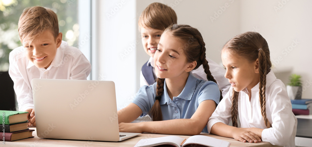 Cute little pupils with laptop in classroom Cute little pupils with laptop in classroom