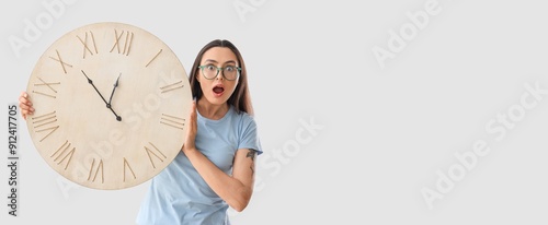 Shocked young woman with cl...