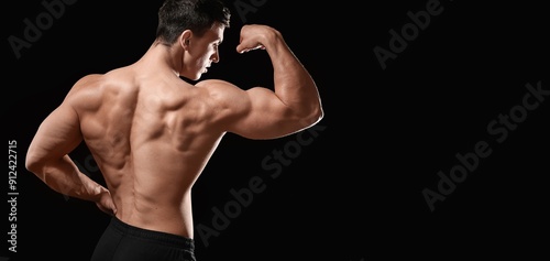 Muscular bodybuilder on dar...