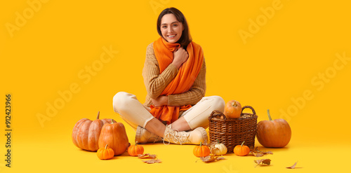 Young woman with pumpkins a...