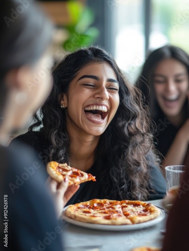 A woman enjoying a slice of pizza with a happy expression