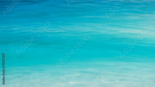 Clear turquoise ocean water gently rippling under sunlight in tropical paradise