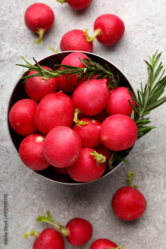 Bowl with fresh radish on light background