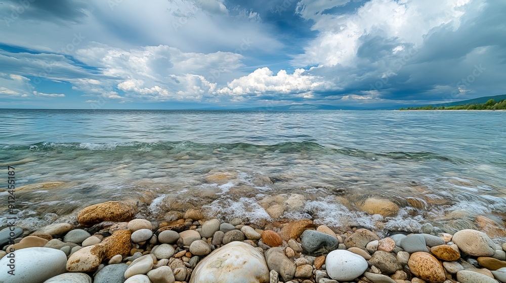 Serene Shoreline With Clear Water and Pebbles Under Cloudy Sky Serene Shoreline With Clear Water and Pebbles Under Cloudy Sky