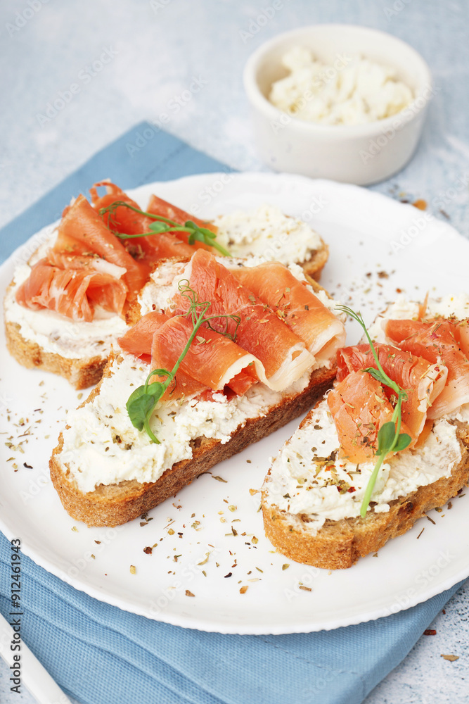 Plate of tasty bruschettas with jamon on light background Plate of tasty bruschettas with jamon on light background