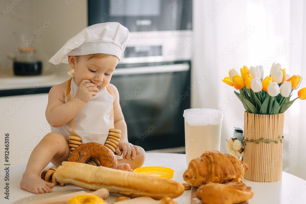 Adorable Baby Dressed as Chef Tasting Freshly Baked Croissants in Kitchen Adorable Baby Dressed as Chef Tasting Freshly Baked Croissants in Kitchen