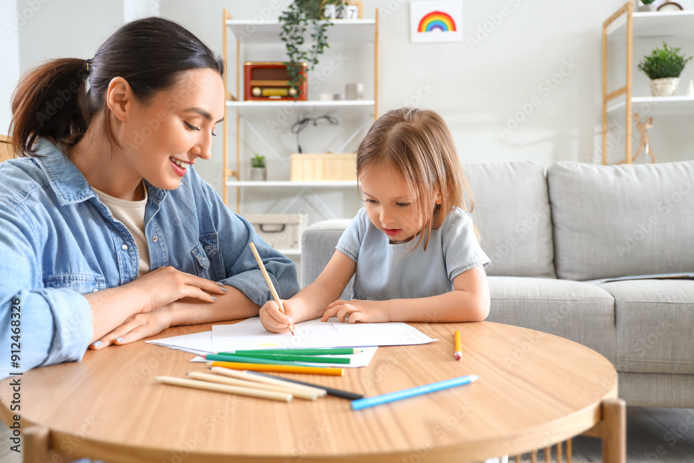 Young woman with her little daughter drawing at home Young woman with her little daughter drawing at home