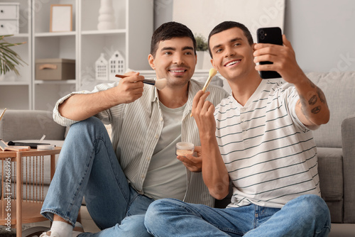 Young men with makeup brush...