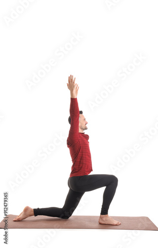 Handsome man doing yoga on ...