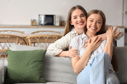 Young lesbian couple huggin...
