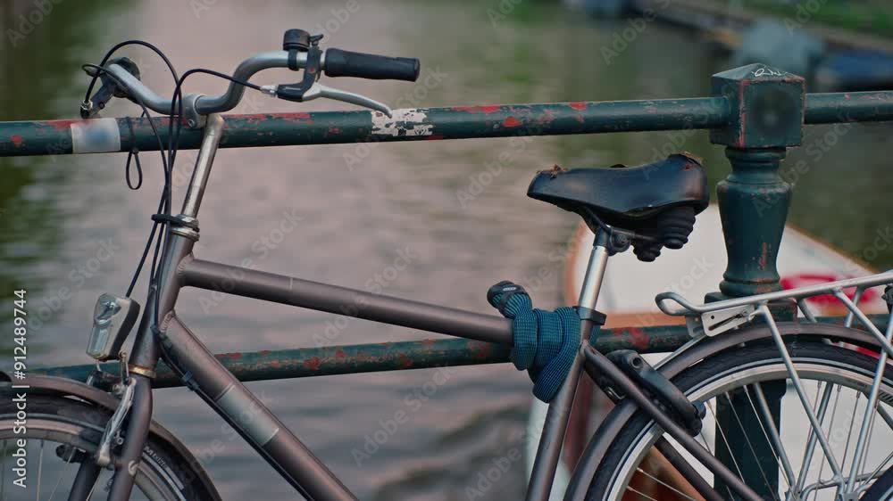 Amsterdam, Netherlands bycicle on a canal in Amsterdam Amsterdam, Netherlands bycicle on a canal in Amsterdam