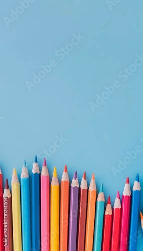 School colored pencils on a blue background, standing like a fence below, free space for text above. Generative AI