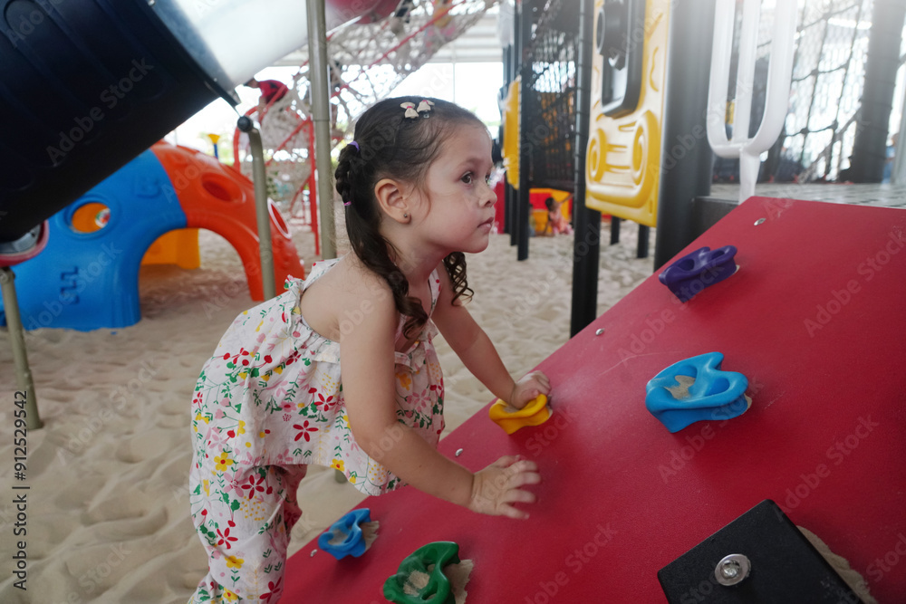 Happy kid having fun on playground in kindergarten.