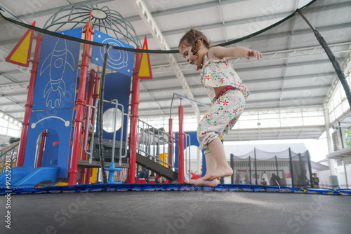 Happy kid having fun on playground in kindergarten.