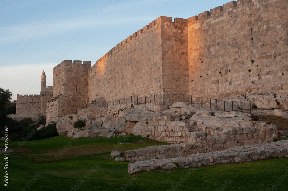 Fototapeta premium Section of the walls of the Old City of Jerusalem and the Tower of David citadel at sunset in Israel.