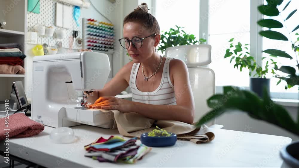 A Creative Woman Engaged in Sewing with a Variety of Colorful Fabrics in a Modern Workspace A Creative Woman Engaged in Sewing with a Variety of Colorful Fabrics in a Modern Workspace