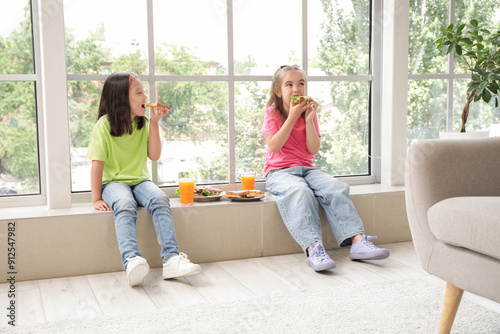 Cute little girls eating ta...