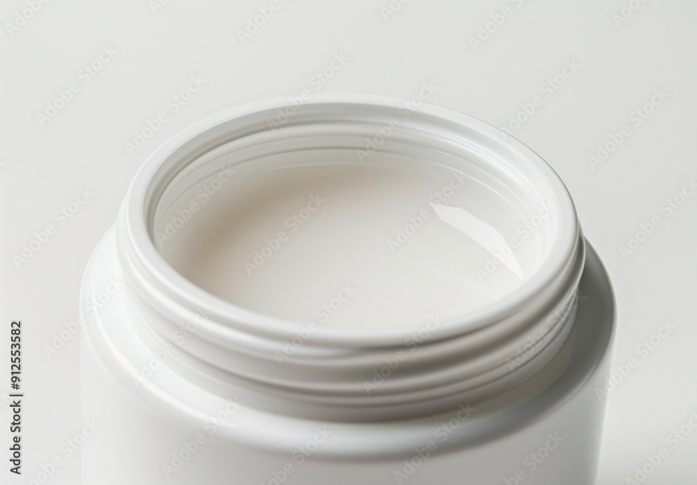 Close-Up of White Cream Jar with Liquid on Top Close-Up of White Cream Jar with Liquid on Top