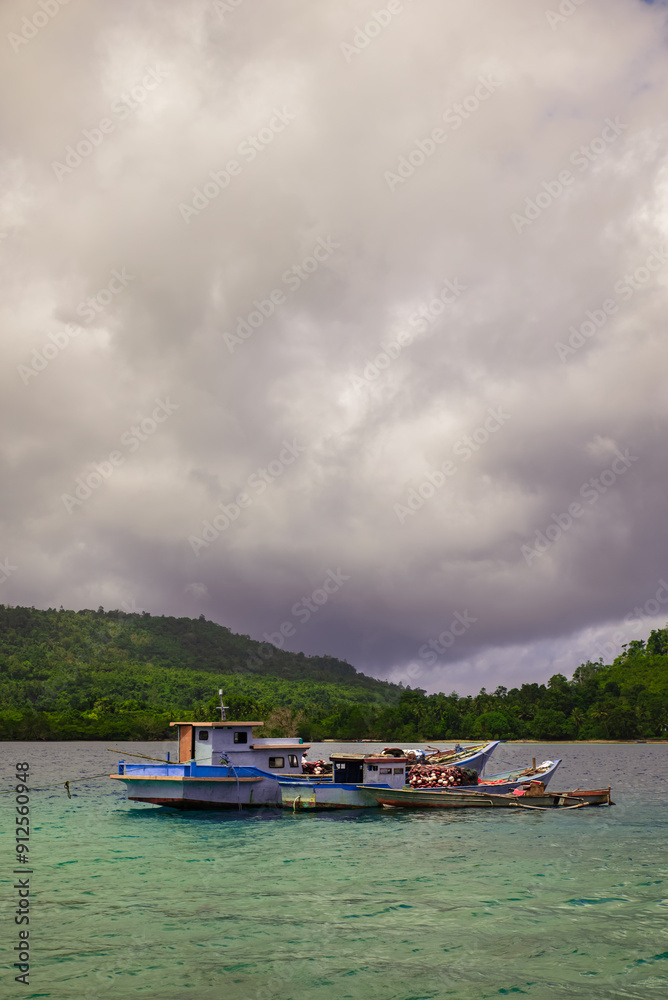 Fishing boats are anchored near the coast Fishing boats are anchored near the coast