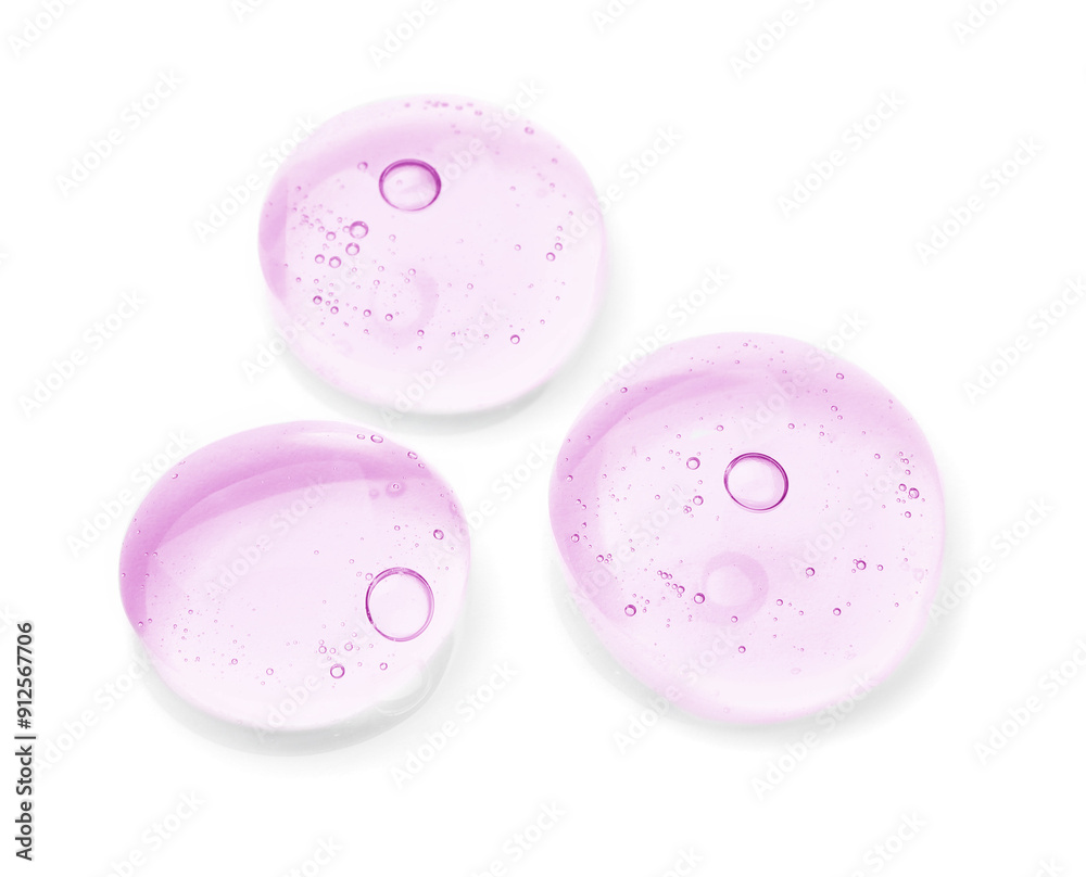 Drops of violet cosmetic oil on white background