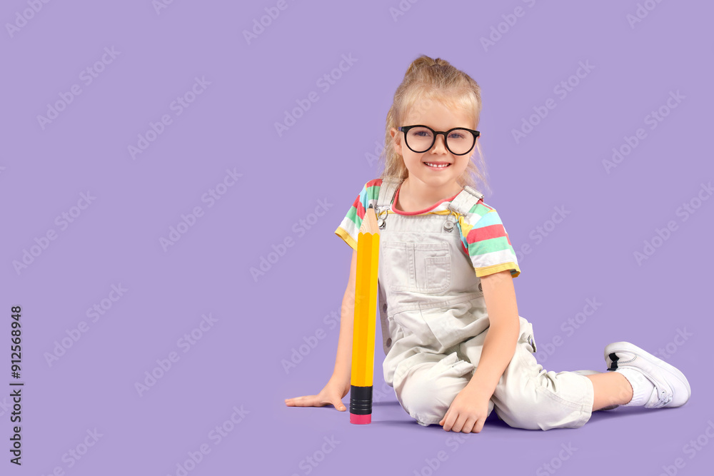 Cute little schoolgirl with big pencil sitting on lilac background Cute little schoolgirl with big pencil sitting on lilac background