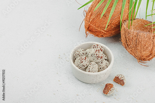 Vegan coconut candies in sesame seeds. Ready to eat food, healthy lifestyle concept photo