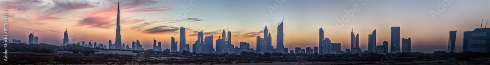Panoramic image of the illuminated skyline of Dubai at dusk after sunset Panoramic image of the illuminated skyline of Dubai at dusk after sunset