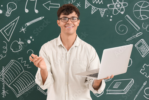 Male teacher with laptop ne...