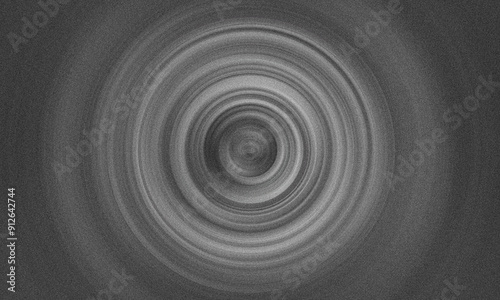 Grey radial motion blur abstract background with noise or grain. Spin circle concentric pattern wallpaper