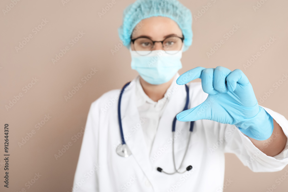 Doctor holding something on beige background, selective focus Doctor holding something on beige background, selective focus
