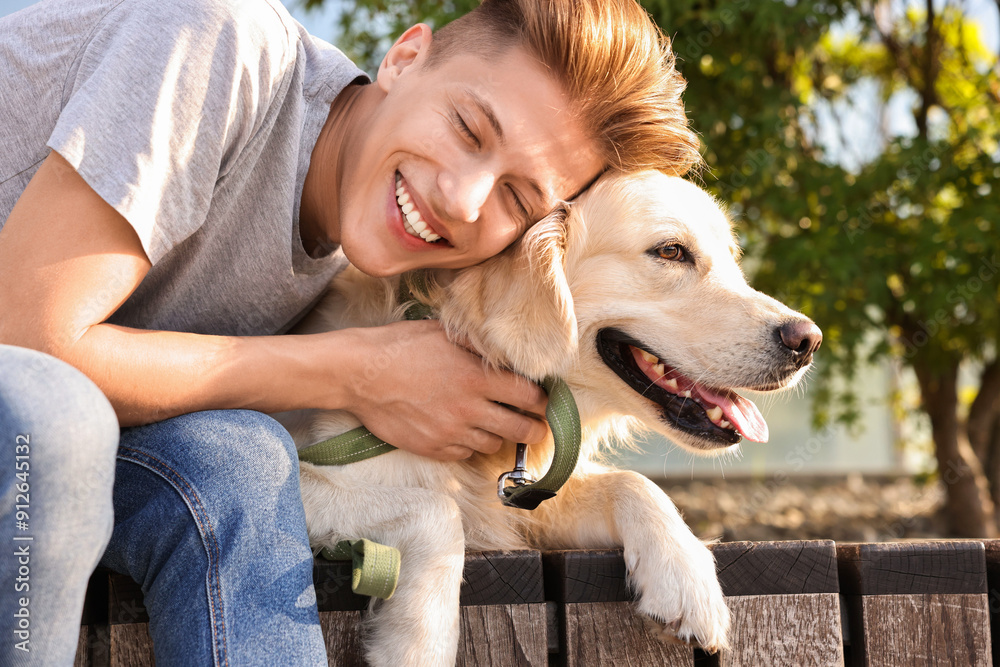 Portrait of happy owner with cute Golden Retriever dog outdoors on sunny day Portrait of happy owner with cute Golden Retriever dog outdoors on sunny day