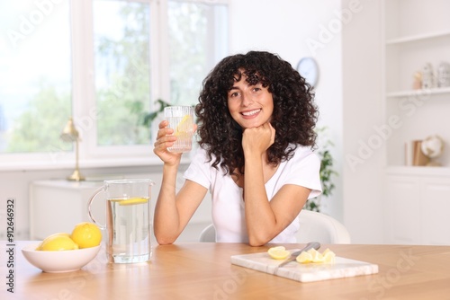 Obraz na płótnie Woman with glass of lemon water indoors