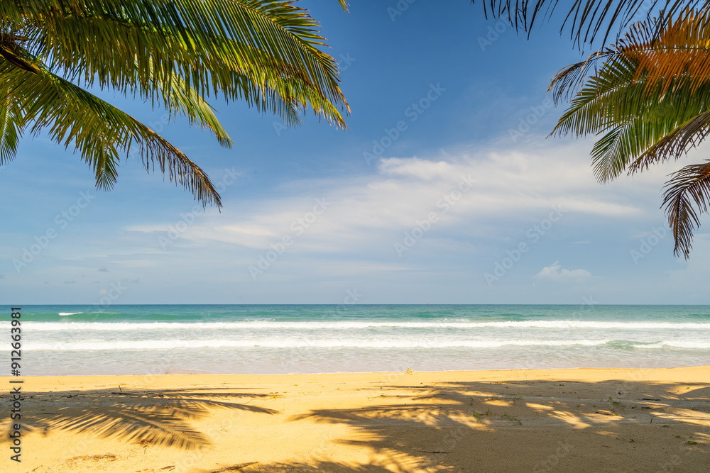 Fototapeta premium Summer background of Coconut Palm trees on white sandy beach Landscape nature view Romantic ocean bay with blue water and clear blue sky over sea at Phuket island Thailand.