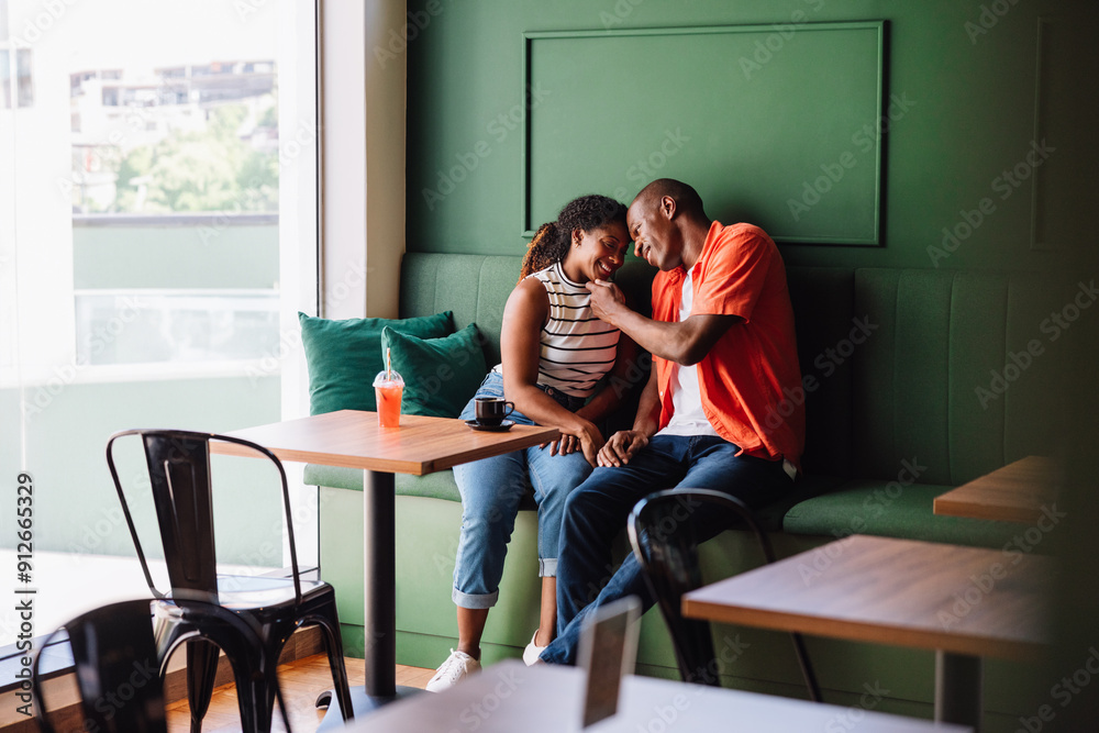 Happy couple sharing a fun moment at a cafe