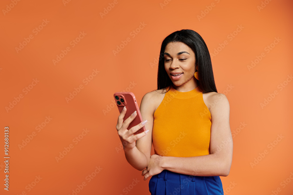 A cheerful woman interacts with her phone, emanating positivity and style. A cheerful woman interacts with her phone, emanating positivity and style.