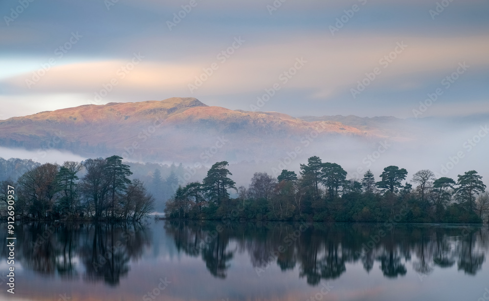 Sunrise over the lake in the mountains of the Lake District National Park