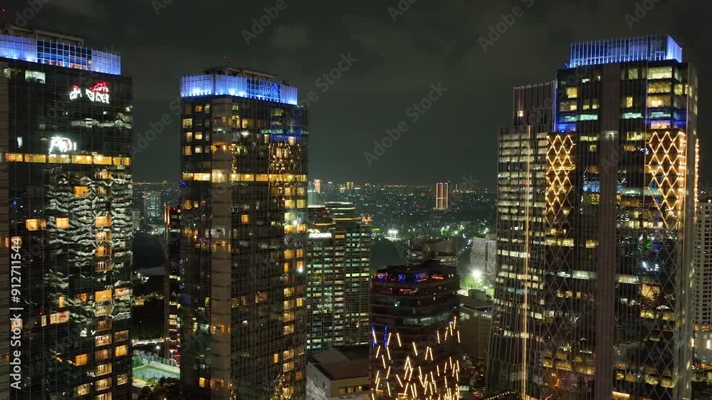 Top view of streets and buildings of Jakarta illuminated at night.