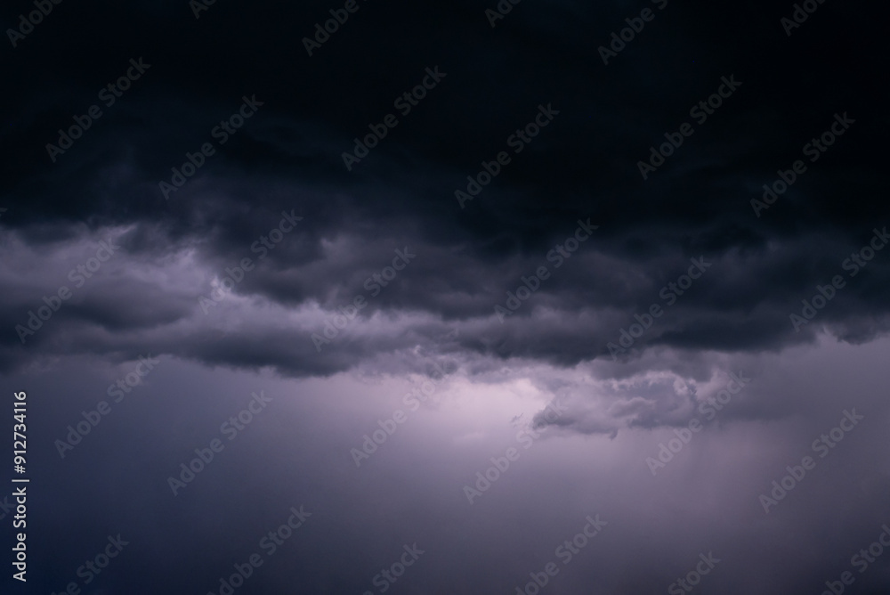 Menacing black clouds on the sky as a sign of coming storm. Concept of weather, rain shower, power and beauty of nature Menacing black clouds on the sky as a sign of coming storm. Concept of weather, rain shower, power and beauty of nature