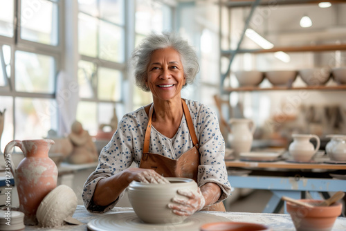 Wallpaper Mural Senior black woman at pottery studio makes ceramic from clay. African american old retired at craft workshop lifestyle. Active elderly female hobby Torontodigital.ca