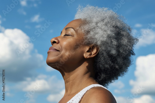 Afro senior woman taking a breath on a sunny day, mental health