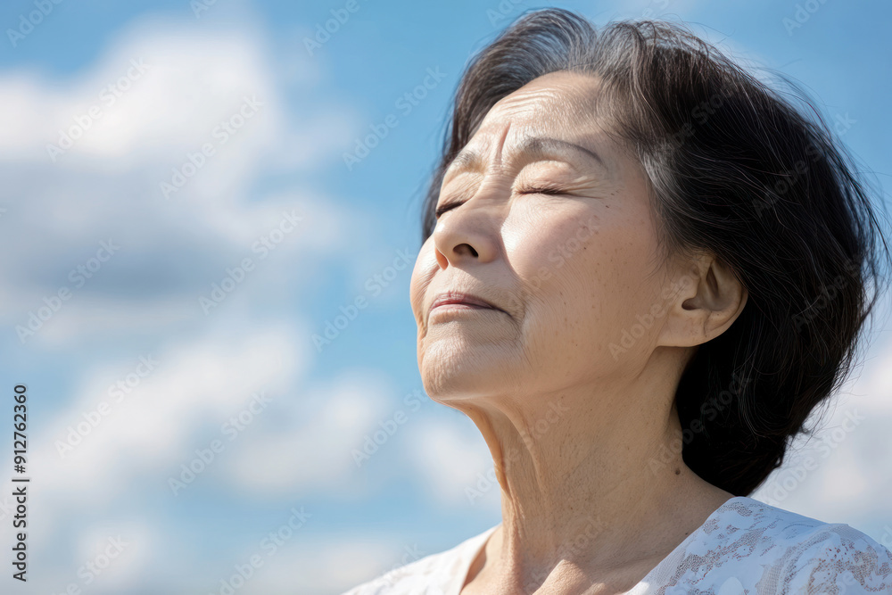 Korean senior woman taking a breath on a sunny day, mental health