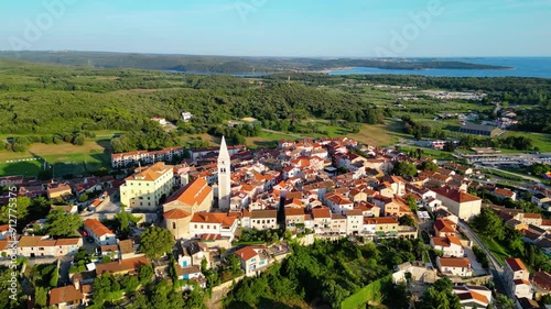 An aerial view of the beautiful old town of Vrsar, Croatia, captured by a drone. This charming coastal town features historic stone buildings, narrow winding streets, and a stunning view  photo