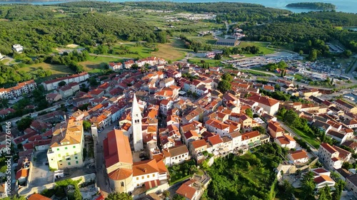 An aerial view of the beautiful old town of Vrsar, Croatia, captured by a drone. This charming coastal town features historic stone buildings, narrow winding streets, and a stunning view  photo