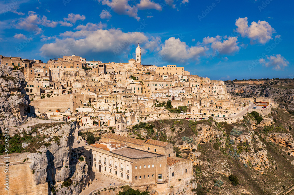 Obraz premium Panoramic view of the ancient town of Matera (Sassi di Matera) in a beautiful autumn day, Basilicata, southern Italy. Stunning view of the village of Matera. Matera is a city on a rocky outcrop.