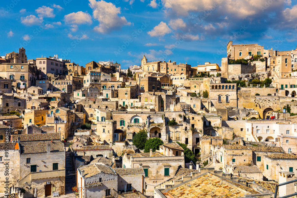 Fototapeta premium Panoramic view of the ancient town of Matera (Sassi di Matera) in a beautiful autumn day, Basilicata, southern Italy. Stunning view of the village of Matera. Matera is a city on a rocky outcrop.