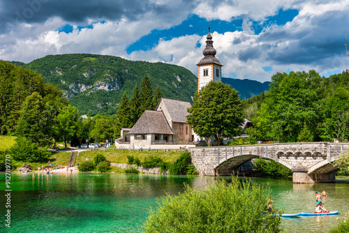 Fototapeta Naklejka Na Ścianę i Meble -  Aerial view of Bohinj lake in Julian Alps. Popular touristic destination in Slovenia. Bohinj Lake, Church of St John the Baptist. Triglav National Park, Julian Alps, Slovenia.