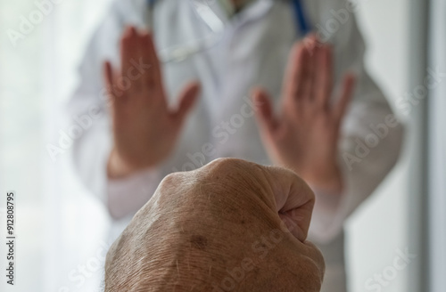 Medical staff abuse. Threatening behaviour towards a doctor, Physician. Angry and violent patient. Zero tolerance.  