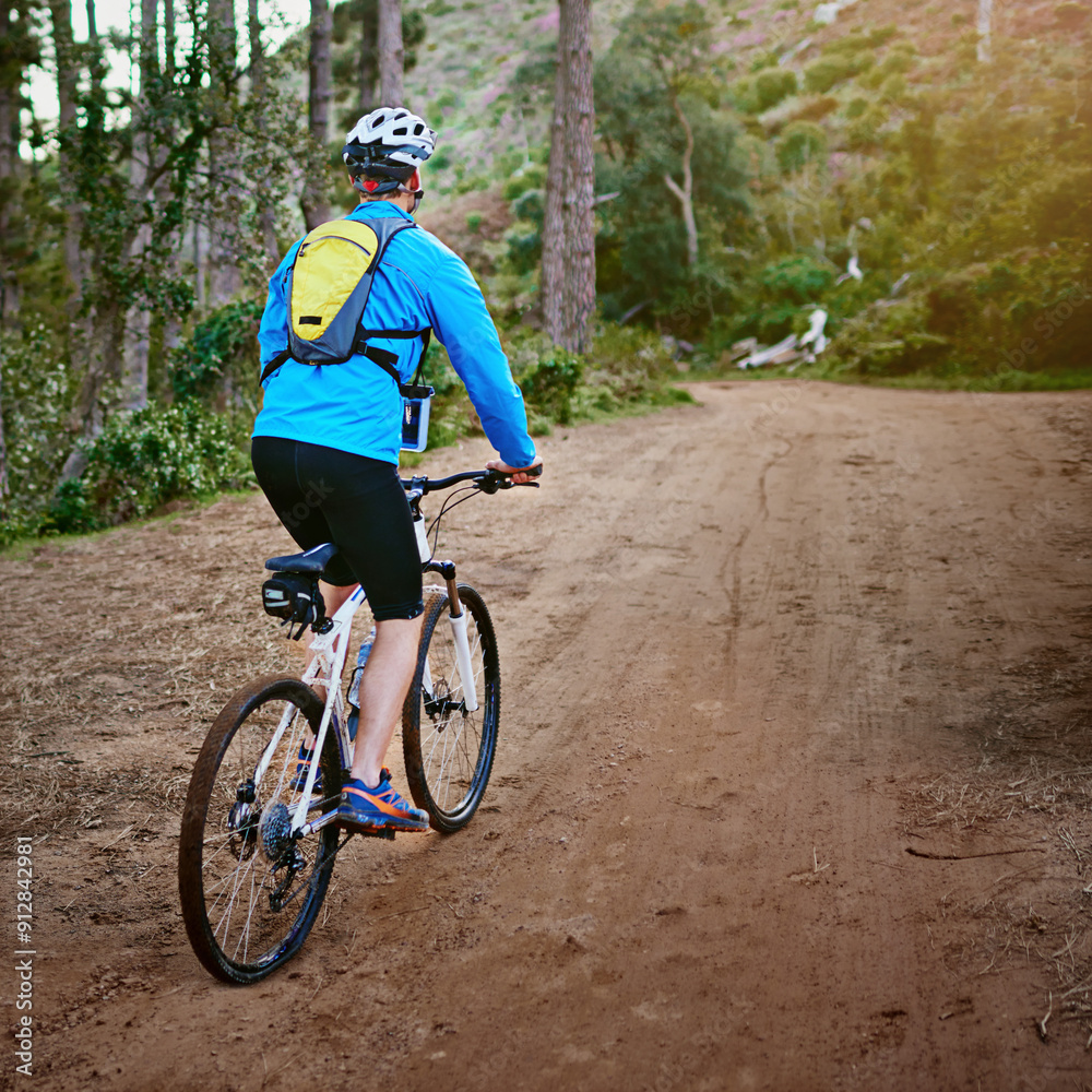 Man, action and mountain off road for bike in outdoor, performance and extreme sports. Male person, athlete back and training in nature for triathlon, forest and riding exercise for fitness challenge Man, action and mountain off road for bike in outdoor, performance and extreme sports. Male person, athlete back and training in nature for triathlon, forest and riding exercise for fitness challenge