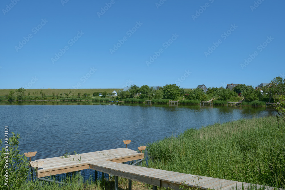 Pond in Spa area of Norderhafen on Nordstrand Peninsula,North Sea,North Frisia,Schleswig-Holstein,Germany Pond in Spa area of Norderhafen on Nordstrand Peninsula,North Sea,North Frisia,Schleswig-Holstein,Germany