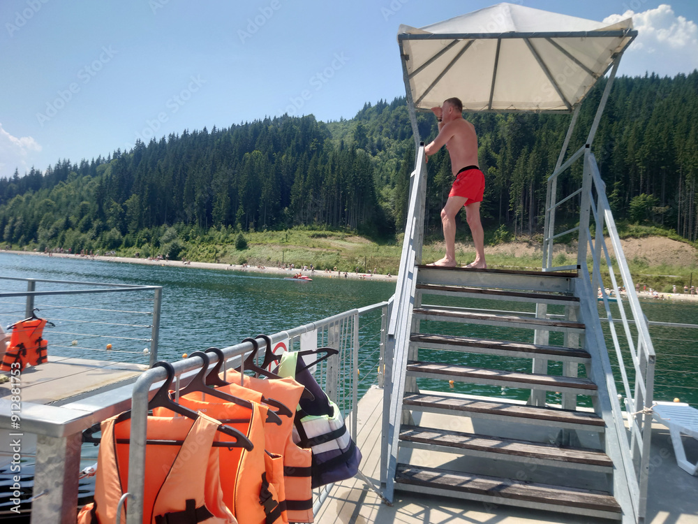 A beach lifeguard watches over swimmers.